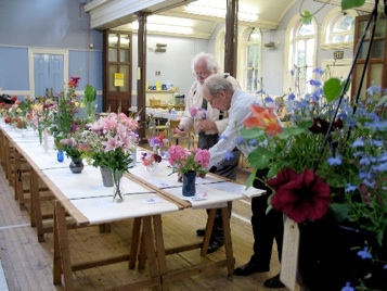 Two judges judging flowers at the show